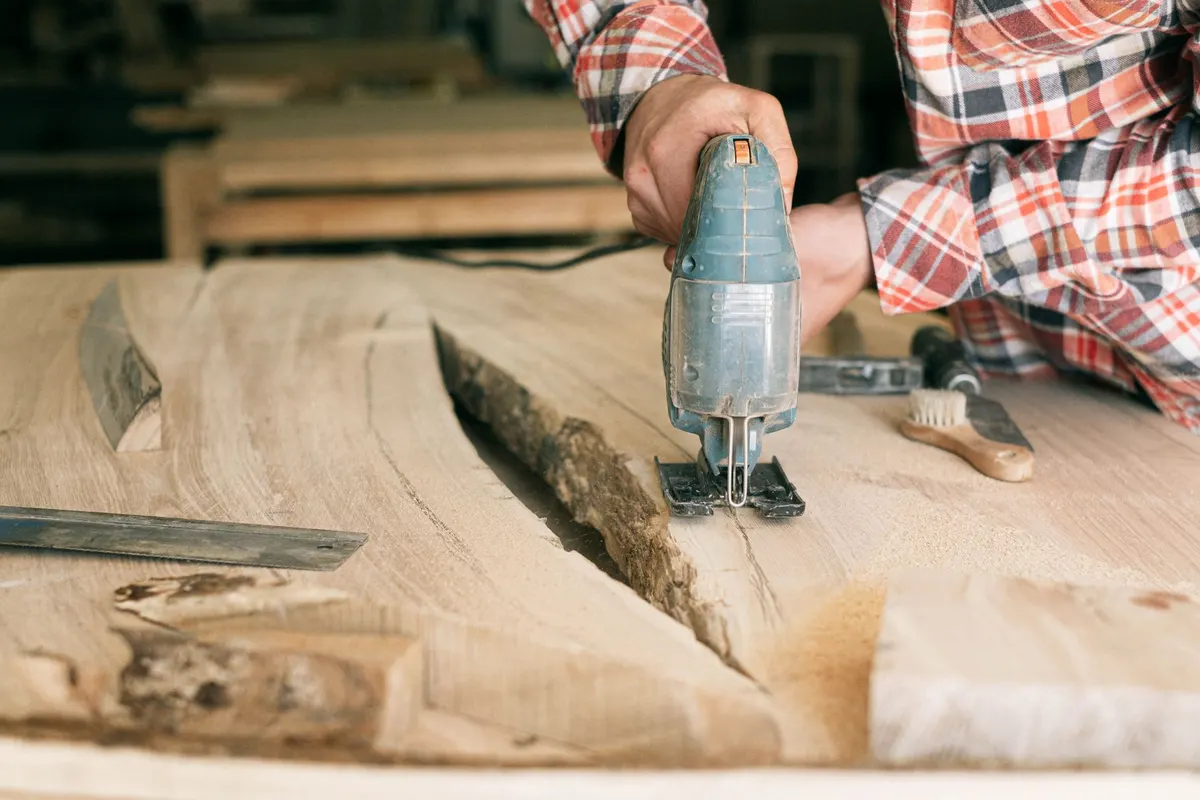 Jigsaw cutting a curved profile in a wooden countertop panel
