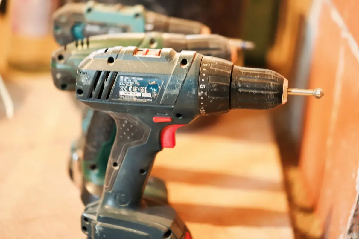 Affordable cordless drill kit on a garage shelf next to home improvement supplies
